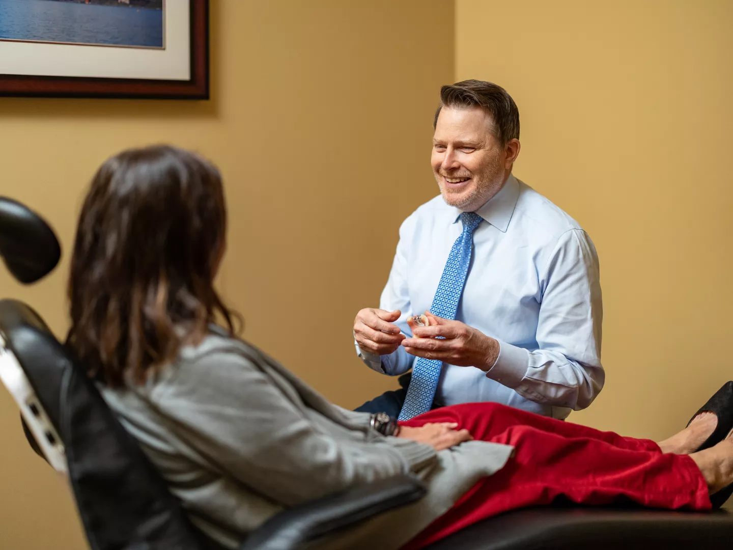 Dr. Clark smiles as he consults with a patient.