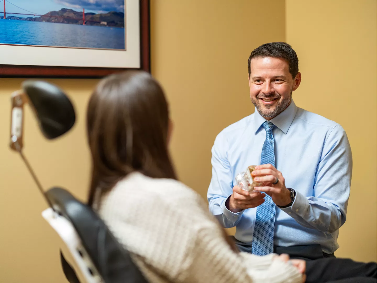 Dr. Lewallen smiles during a consultation with a patient.