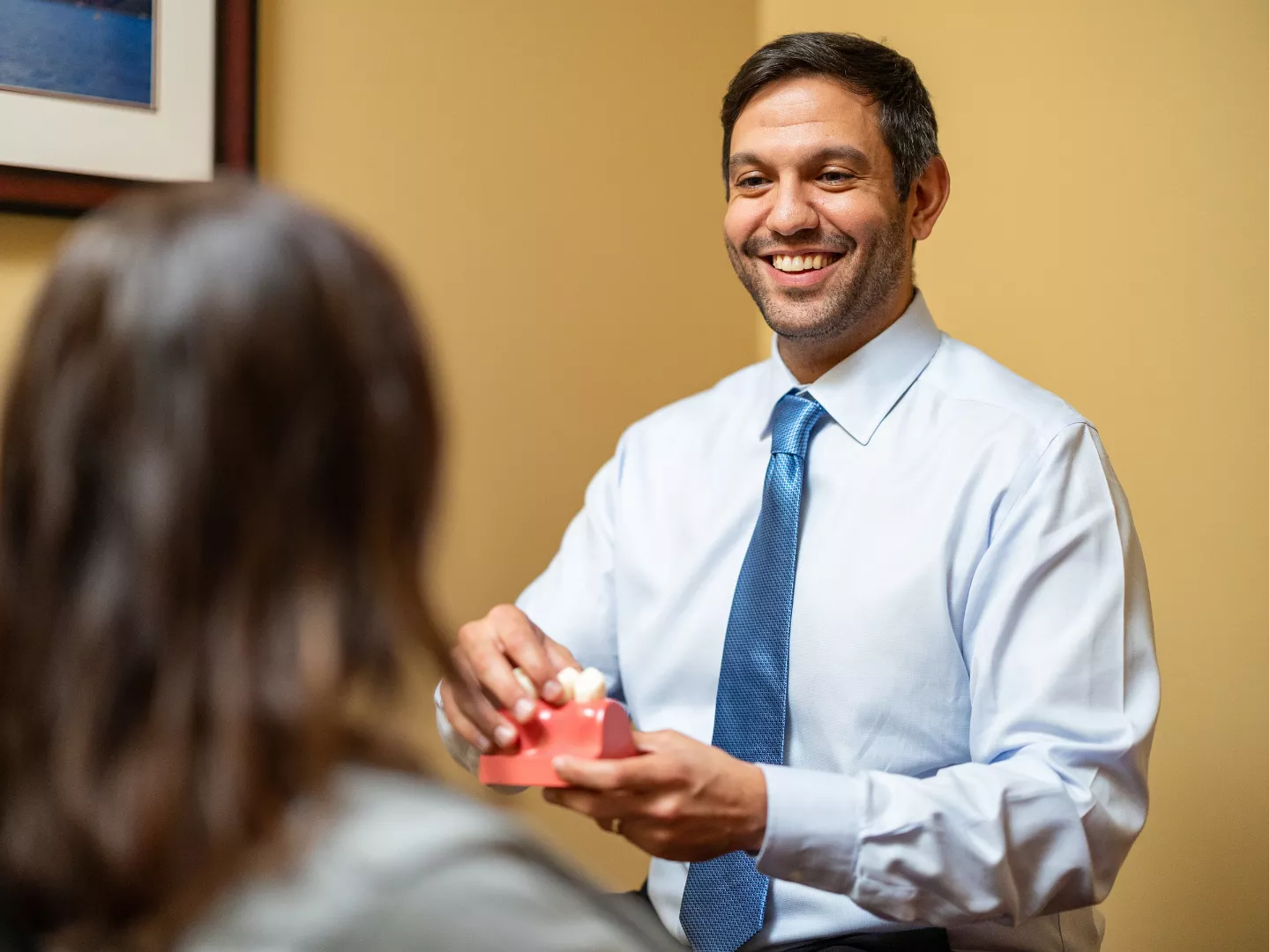 Dr. Lotesto smiles during a consultation with a patient.