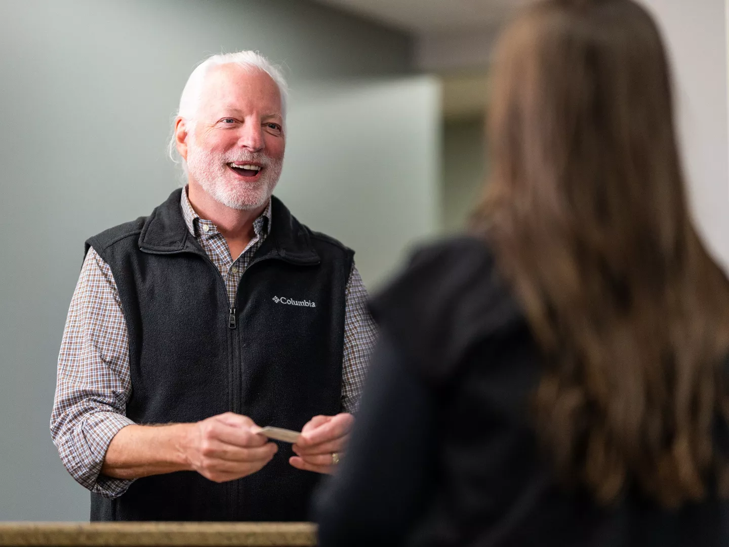Team member interacting with patient at reception.