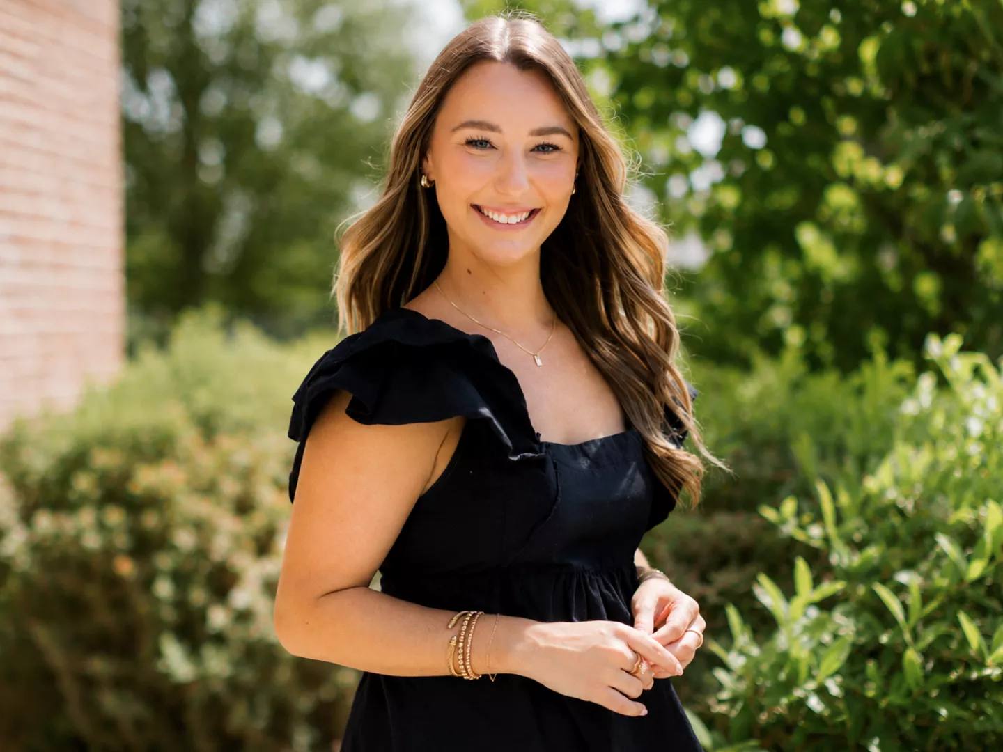 Image of a beautiful woman smiling outdoors.