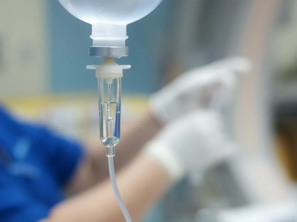 IV sedation being shown with a bag placed on a pole and dripping.