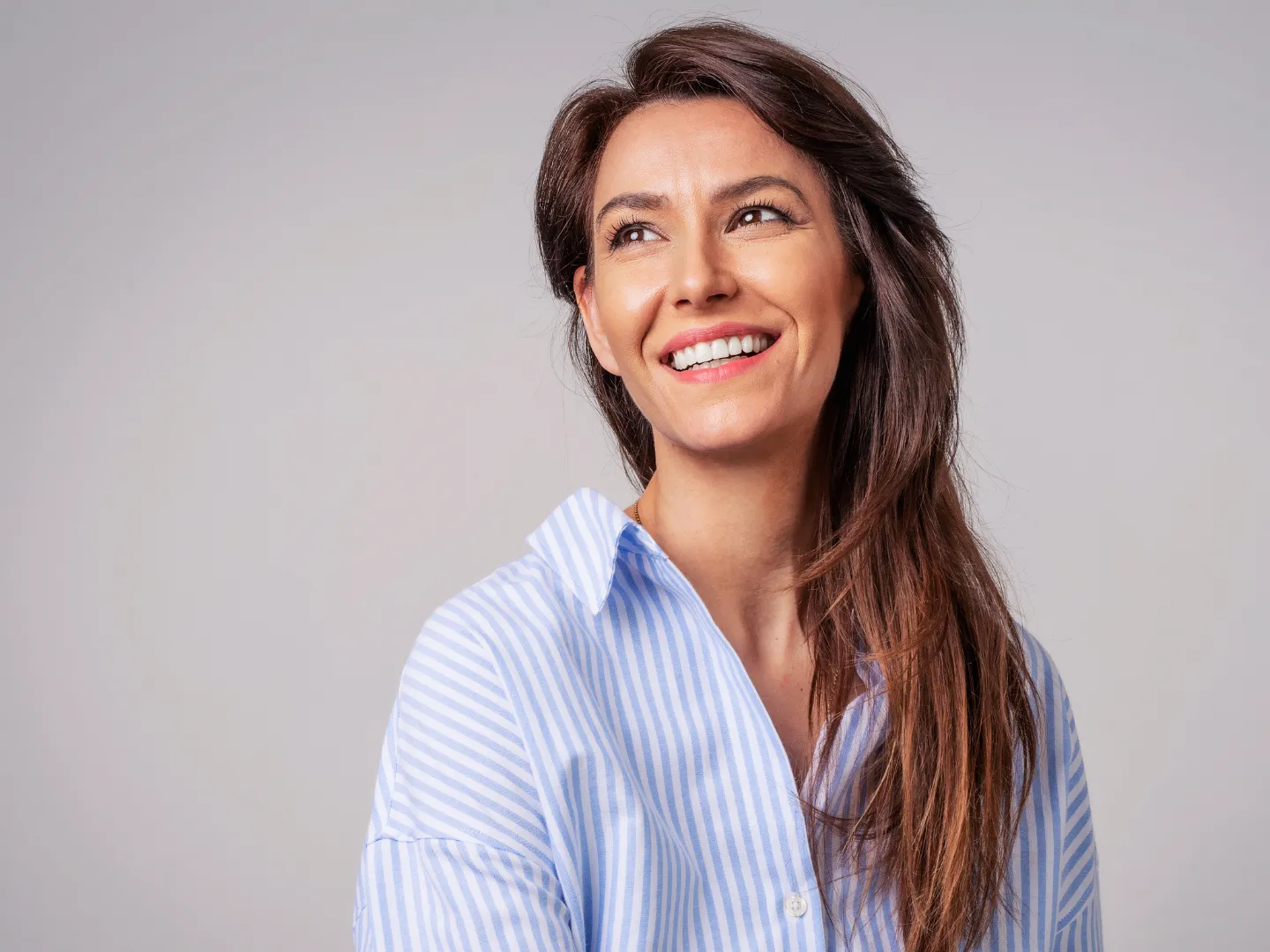 Studio picture of a woman smiling.