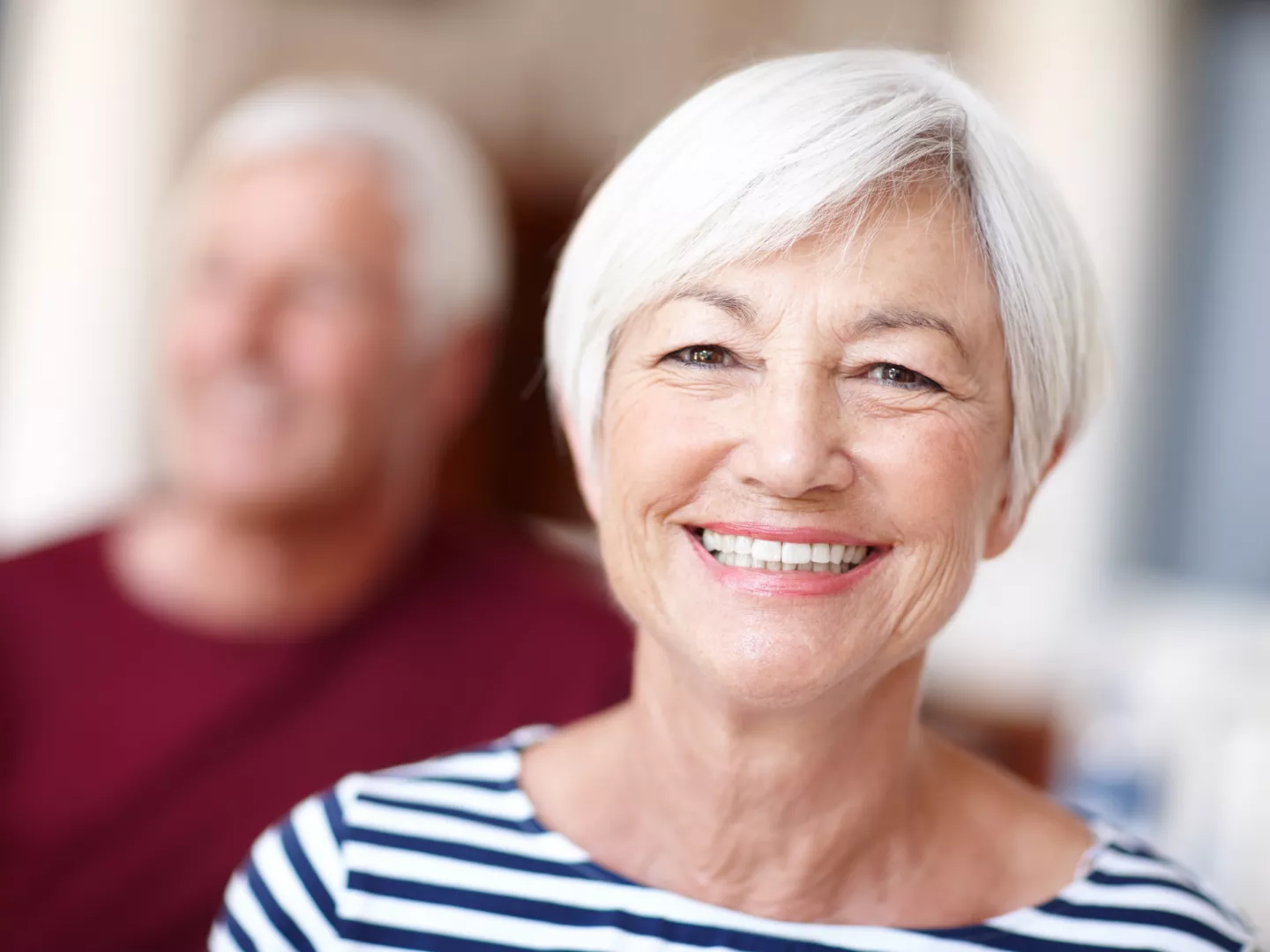 A couple with a woman in the focus smiling.